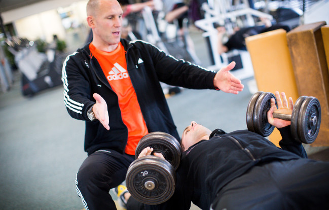 Sport Lecturer Mat Blair works with a student in the gym